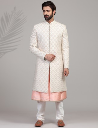 A set of silk sherwani in peach and cream